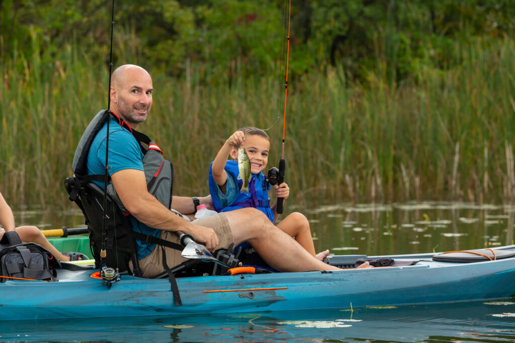 Battalion Bait Dad & Son Fishing. Boy Holding Small Mouth Bass.